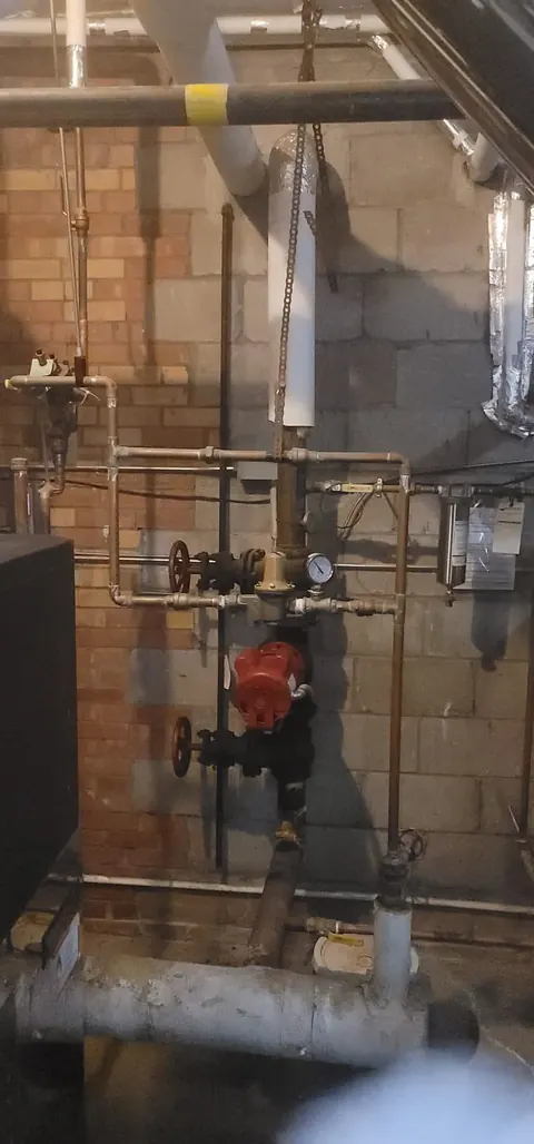 Boiler room with copper piping, valves and a circulator pump