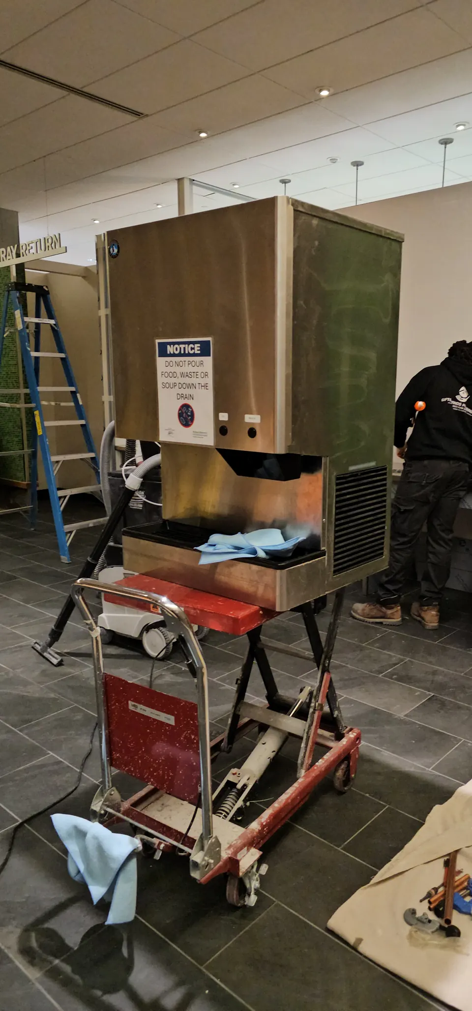 Commercial ice machine plumbed in during a fit-out