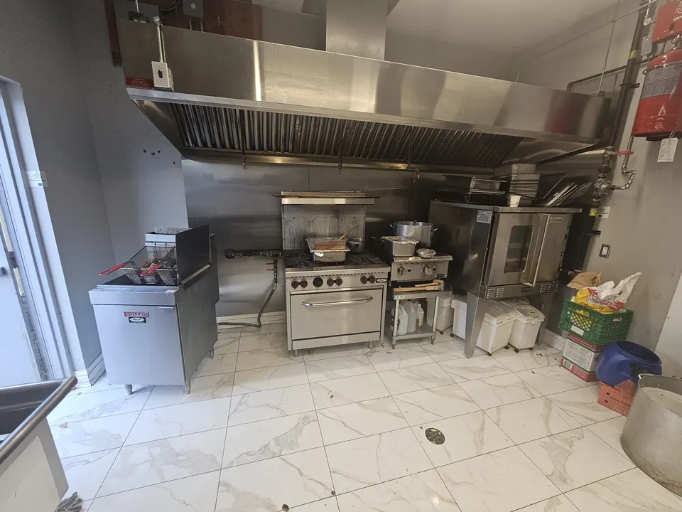 Finished commercial kitchen line with sinks and equipment plumbed