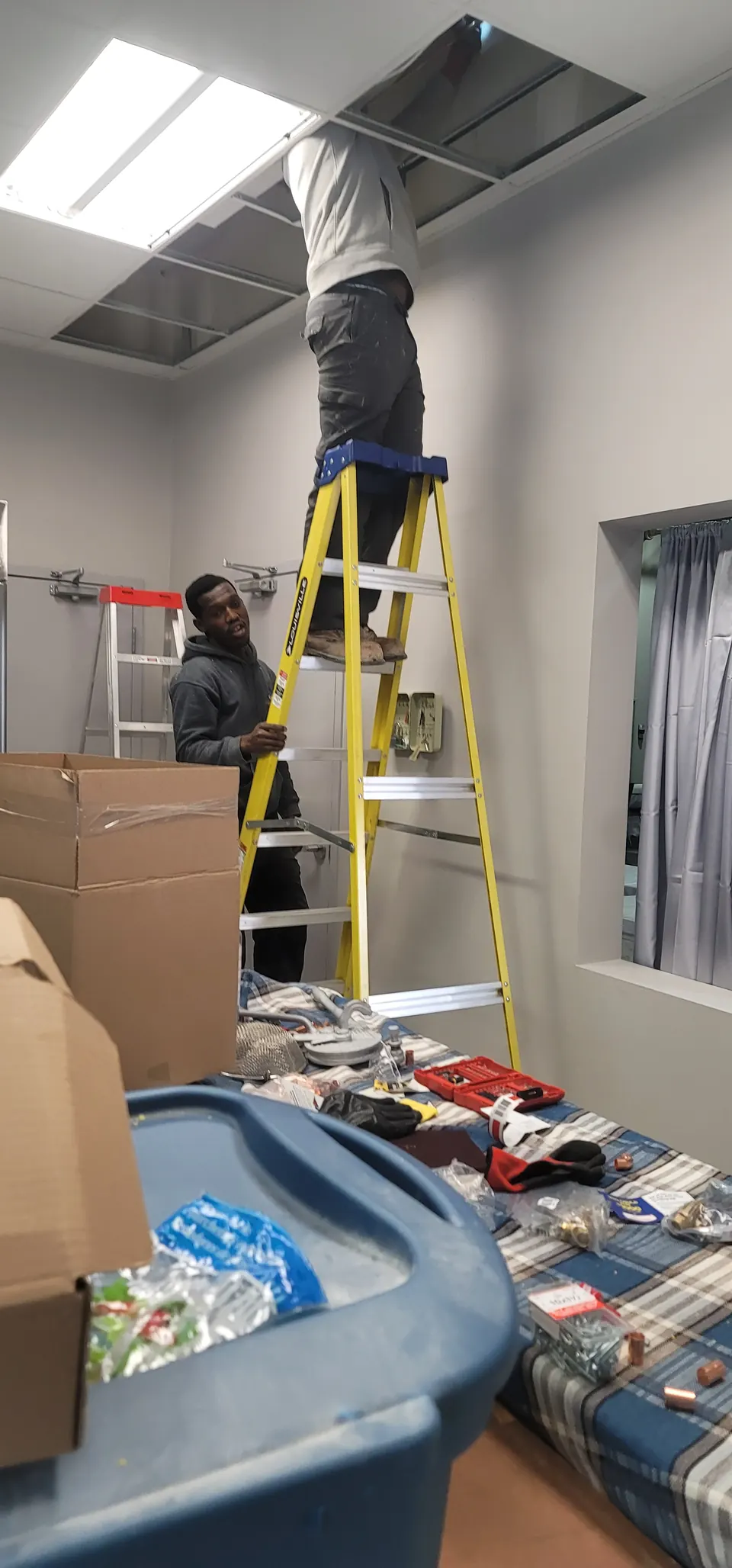 GiftedHands crew on ladders during a commercial unit fit-out