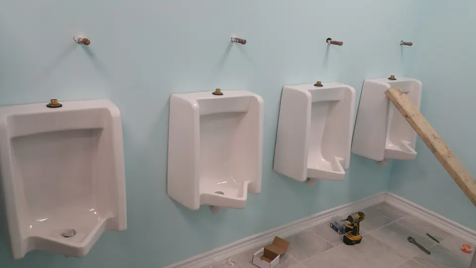 Row of urinals installed in a commercial washroom
