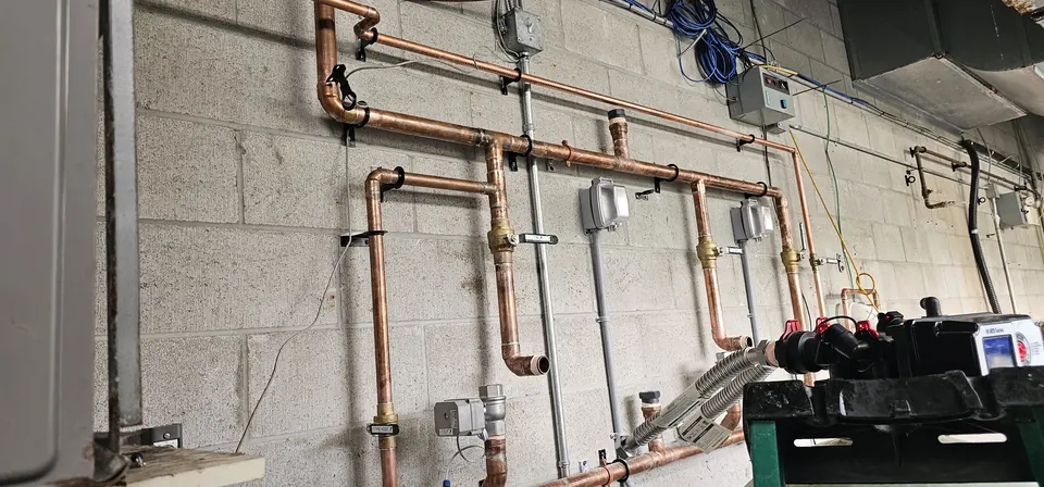 Copper water distribution piping across a block wall