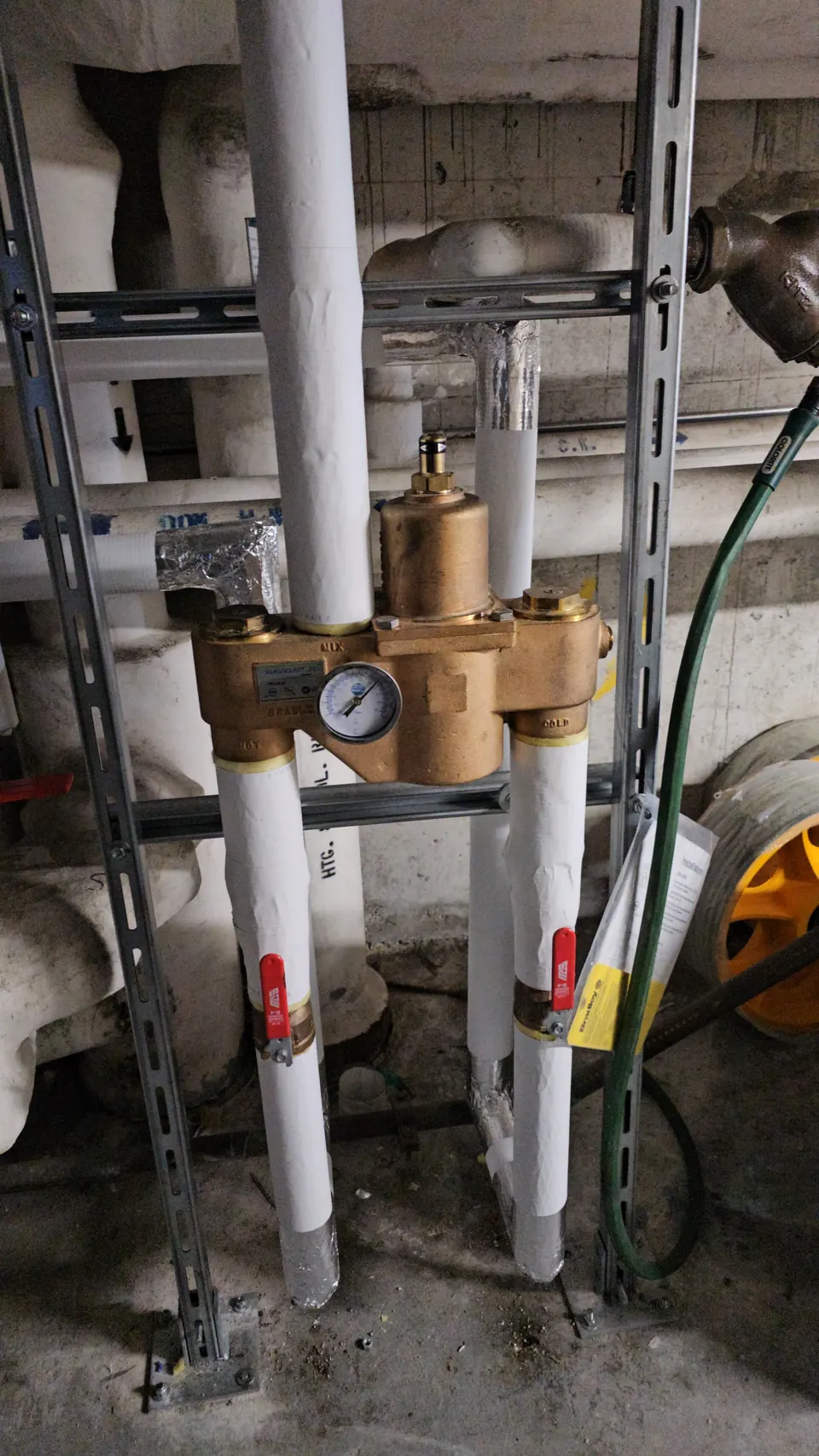Thermostatic mixing valve with gauge in a mechanical room