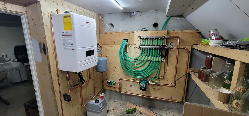 Wall-hung boiler feeding a radiant floor heating manifold