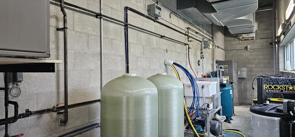 Water treatment tanks installed in a commercial equipment room